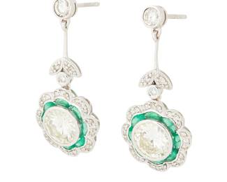 264
A Pair of Platinum, Emerald and Diamond Earrings
Centering two round diamonds weighing 1.33 and 1.39 carats, encircled by French-cut emeralds, accented by round diamonds
2 pieces

Measures: 1 1/4 x 5/8 in.
8.7 grams gross
Estimate: $3,500 - $4,500
