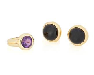 131
Tiffany & Co: An 18K Gold and Gem-Set Ring and Pair of Earrings
Including a ring featuring a round amethyst set in a high polish design, together with a pair of earrings centering two round onyx cabochons, all signed Tiffany
3 pieces

Ring: 5, Earrings: 5/8 x 5/8 in.
24.3 grams gross
Estimate: $1,500 - $2,500