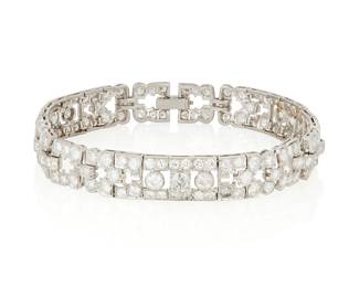 111
An Art Deco Platinum and Diamond Bracelet
Of a geometric design featuring old European-cut and transitional-cut diamonds weighing approximately 6.75 carats, c.1930

Length: 7 1/2 in.
26.1 grams gross
Estimate: $5,000 - $7,000