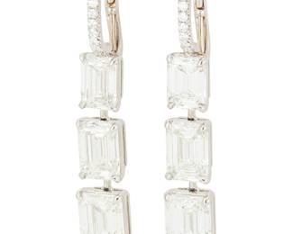 118
A Pair of Platinum and Diamond Earrings
Featuring six emerald-cut graduated diamonds weighing 9.05 carats, accented by half round small hoop set with round diamonds
2 pieces

Measures: 1 1/2 in.
9.4 grams gross

Accompanied by 6 GIA reports stating that the diamond weight ranges from ranging from 1.01 - 2.01 carats, G - I color, VVS1 - VVS2 clarity.

Click Here to download and view the GIA certificates for this lot.
Estimate: $50,000 - $75,000