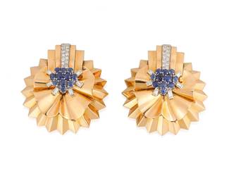 15
A Pair of Retro Rose Gold, Diamond and Sapphire Clips
Of a circular fan design, centering round sapphires accented by single-cut and baguette diamonds weighing approximately 1.35 carats, c. 1940's
2 pieces

Measures: 1 7/8 x 1 3/4 in.
42.8 grams gross
Estimate: $12,000 - $18,000