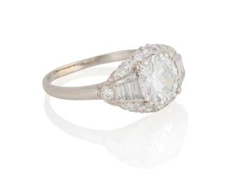 71
A Platinum and Diamond Ring
Centering a round brilliant-cut diamond weighing 1.51 carats, accented by round and baguette diamonds

Size: 8
3.4 grams gross

Accompanied by a GIA Report numbered #6233571815, dated April 28, 2025, stating the diamond as Natural with a color grade of E and a clarity grade of VS2, medium blue fluorescence.
Estimate: $4,500 - $6,500