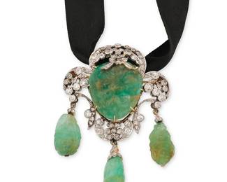 58
A Platinum Topped-Gold, Emerald and Diamond Pendant/Brooch
Featuring carved emeralds of a floral design in an ornate frame set with old mine-cut and rose-cut diamonds weighing approximately 2.00 carats, suspending on a black cord

Measures: 2 1/2 x 1 3/4 in.
30.6 grams gross
Estimate: $2,000 - $3,000