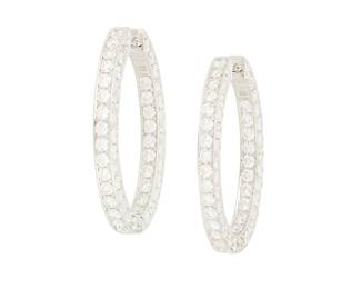 253
A Pair of 18K White Gold and Diamond Hoop Earrings
Of an oval design featuring round diamonds weighing approximately 12.05 carats total
2 pieces

Measures: 1 1/4 in.
12.2 grams gross
Estimate: $8,000 - $12,000