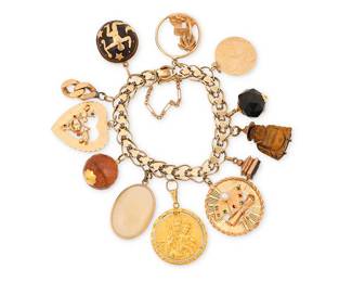 12
A Gold Charm Bracelet
Suspending twelve charms including a kukui nut, a carved tiger's eye buddha and an island scene

Length: 7 1/4 in.
103.0 grams gross
Estimate: $3,500 - $4,500