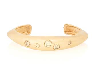 40
A 14K Gold and Colored Diamond Bangle
Featuring five round diamonds weighing approximately 3.00 carats

Measures: 6 in., Gap: 1 1/4 in.
30.6 grams gross
Estimate: $4,000 - $6,000