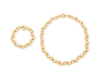 228
An 18K Gold Necklace and Bracelet Set
Featuring textured gold open links centering high polish gold beads, with Italian assay marks
2 pieces

Necklace: 18 in., Bracelet: 8 in.
55.7 grams gross
Estimate: $2,200 - $2,800