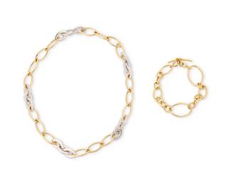 217
A Bi-Color Gold Necklace and Gold Bracelet
Including a 14k bi-color gold marquise-shaped link necklace together with an 18k gold open link bracelet
2 pieces

Necklace: 19 1/2 in. Bracelet 8 1/2 in.
40.5 grams gross
Estimate: $1,500 - $2,500