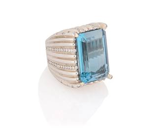 191
An 18K White Gold, Blue Topaz, and Diamond Ring
Centering an emerald-cut blue topaz weighing approximately 33.05 carats, accented by round diamonds weighing approximately 1.00 carat, with Italian maker's marks

Size: 7, Top Measures: 1 1/8 x 3/4 in.
45.2 grams gross
Estimate: $6,000 - $8,000