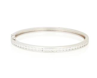 243
An 18K White Gold and Diamond Bangle
Of a hinged design featuring a row of round channel-set diamonds weighing approximately 1.04 carats

Measures: 6 1/2 in.
17.1 grams gross
Estimate: $2,000 - $3,000