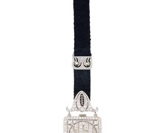 246
Tiffany & Co.: A Platinum and Diamond Lapel Watch
Dial: 19.30 mm round with Roman numeral hour markers
Movement: J Robert no. 6798
Case: 1 x 1 in., finished with single-cut diamonds weighing approximately 3.00 carats
Closure: silk cord finished with a platinum and diamond set brooch
Signed: dial, monogrammed NGL

Measures: 4 1/2 x 1 in.
24.6 grams gross
Estimate: $3,000 - $5,000