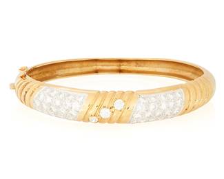 17
A 14K Gold and Diamond Bangle
Of a hinged design featuring elements set with round diamonds weighing approximately 4.05 carats

Inner circumference: 7 1/4 in.
35.4 grams gross
Estimate: $3,500 - $4,500