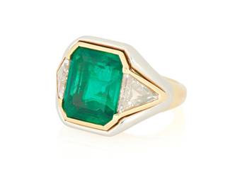 119
Bulgari: An 18K Bi-Color Gold, Emerald and Diamond Ring
Centering an emerald-cut emerald weighing approximately 6.40 carats, accented by two triangular-cut diamonds weighing 2.28 carats, signed Bvlgari, no.c3081

Size: 7 1/2
15.3 grams gross

Accompanied by a AGL Report numbered #1149525, dated July 28, 2025, stating the Emerald as natural Beryl of Colombian origin with Minor Traditional clarity enhancement.
Estimate: $55,000 - $75,000