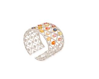214
An 18K White Gold, Colored Sapphire, and Diamond Cuff
Of a flexible lattice design featuring oval fancy-colored sapphires of orange, yellow, blue, pink and purple, accented by round diamonds weighing approximately 2.22 carats

Measures: 6 in., Gap: 1/2 in., Width: 1 1/2 in.
65.5 grams gross
Estimate: $6,000 - $8,000