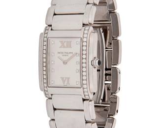 305
Patek Philippe: A Stainless-Steel and Diamond 'Twenty 4' Watch
Dial: 15.90 mm, Rectangular with roman numeral and diamond inset hour markers, accented by round diamonds weighing approximately 0.54 carat
Model: Twenty 4
Case: 26.00 mm, 4093795
Closure: stainless- steel band with butterfly clasp
Signed: dial and clasp, with original box

Inner circumference: 5 1/2 in.
77.0 grams gross
Estimate: $5,000 - $7,000