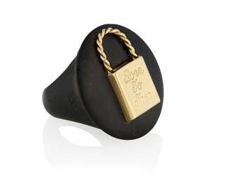 179
A 14K Gold and Wood Ring
Of a carved wood design centering a gold bag labeled "Born to Shop", with maker's mark, Italy, c.1960s

Size: 6 1/2
6.69 grams gross
Estimate: $800 - $1,200