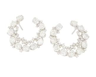 188
A Pair of 18K White Gold and Diamond Earrings
Of a crescent design set with round diamonds weighing approximately 8.10 carats
2 pieces

Measures: 1 x 1 in.
10.4 grams gross
Estimate: $3,000 - $4,000