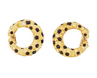 41
A Pair of 18K Gold, Colored Diamond and Onyx Earclips
Of a crescent design featuring round yellow diamonds weighing approximately 4.00 carats, accented by variously cut onyx cabochons
2 pieces

Measures: 1 x 1 in.
14.1 grams gross
Estimate: $4,000 - $6,000