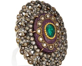 52
A Mughal Style Ruby and Diamond Ring
Centering a carved ruby set with an oval foil backed beryl accented by rose cut diamonds set in an intricate frame

Size: 8 1/4, measures: 2 1/4 x 2 in.
38.2 grams gross
Estimate: $2,000 - $3,000