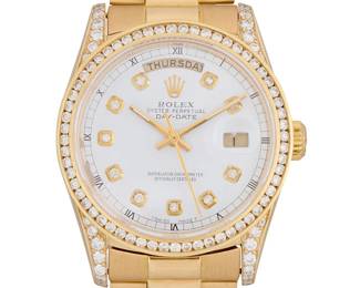 303
An 18K Gold and Diamond Watch
Dial: 30.00 mm, White dial, day/date apertures, applied diamond hour markers, accented by aftermarket round diamonds weighing approximately 2.15 carats
Model: Day-date president
Case: 35.00mm
Case number: serial: W583447 (1995), ref: 18038
Closure: 18k gold bracelet with rose gold deployment clasp
Signed: dial and clasp
Please note that except for the diamonds, all parts of this watch are Rolex and have been authenticated but they are from different watches

Inner circumference: 6 1/2 in.
120.6 grams gross
Estimate: $6,000 - $8,000
