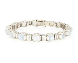 200
A Platinum, Moonstone and Diamond Bracelet
Featuring graduated round moonstone cabochons accented by baguette diamonds weighing approximately 3.85 carats, with French assay and makers mark, c.1940

Length: 7 x 1/4 in.
34.0 grams gross
Estimate: $8,000 - $12,000