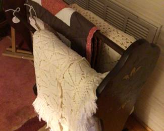 Pennsylvania Dutch quilt rack with quilts and crocheted bedspreads 