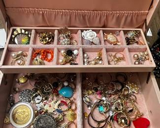 Elegant Jewelry Box with Assorted Earrings, Brooches, and Rings in Various Designs and Colors
