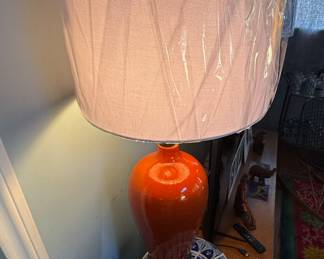 A pair of orange tall MCM table lamps