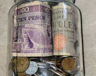 Jar filled with foreign money from all around the world.