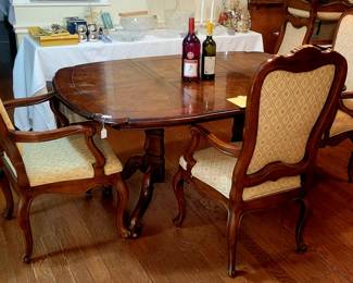 Dining room table with two leaves and six chairs.