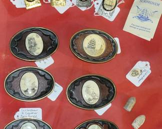 Scrimshawed belt buckles and money clips.