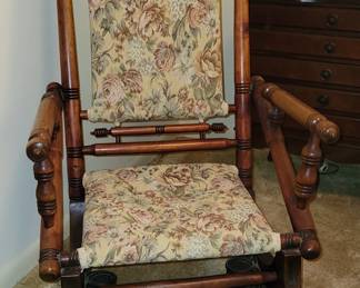 Antique spindle-style glider chair.