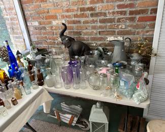 Leather elephant and antique bottles 