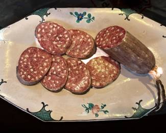 Troupe-l’ceil Ceramic Plate
Troupe-l’ceil means “trick the eye.” The salami is actually three dimensional ceramic food crafted to resemble the real thing.
