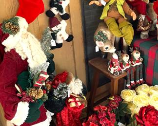 More Christmas. Large standing Santa. Buckets full of floral stems.