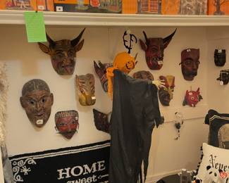Large collection of Halloween masks and a collection of Halloween Department 56 village structures/figures.