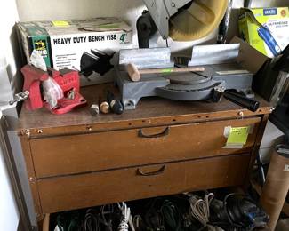 Mikita adjustable miter saw. Vintage Wilton Swivel base red bench vise. New in box (N.I.B.) Ohio forge adjustable , 4" bench vice. Three drawer wooden dresser storage cabinet.