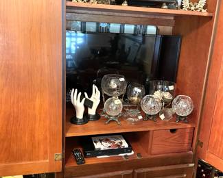 TV, Blu-Ray DVD player/remotes. Several pressed glass globes on pedestals. Vintage "hands" remote holder.