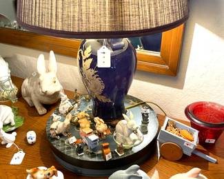 Miniature rabbits at base of vintage lamp.