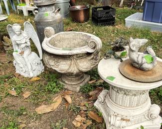 Seated angel, large urn, large sturdy pedestal, vintage milk can behind urn.