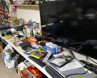 Large screen Samsung tv and DVD player. Tables full of garage appliances, tools and supplies. Many items in new unopened boxes. Multiple shop vacs, garage heaters etc.