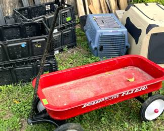 Heavy set of sawhorses, storage bins, two portable dog kennels, and a nice red wagon.