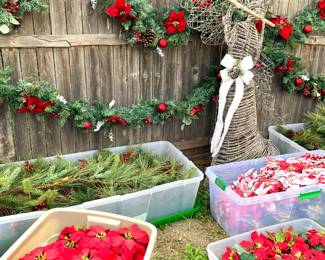 Crates full of floral Christmas decorations.
