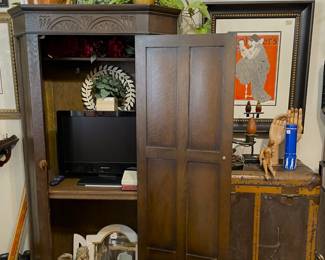 Notice old steamer trunk to the right of carved vintage armoire.