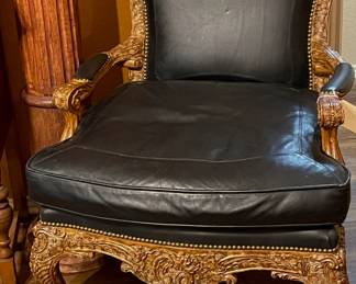 Leather, ornate wooden side chair.