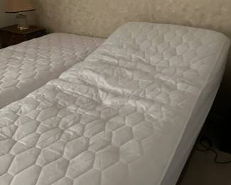 Adjustable twin beds, extra long, can be put together as one bed.