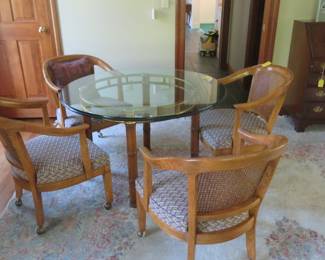 Vintage faux bamboo & glass table with four barrel cane back Italian Regency chairs.