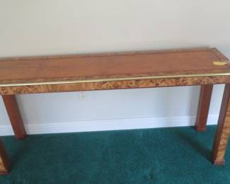 Magnificent wooden sofa table with brass and burled wood.