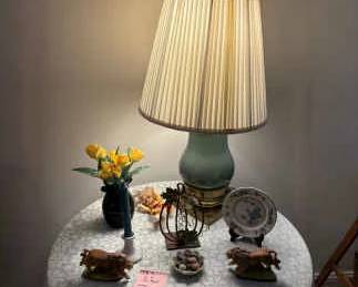 Round Particleboard Table With Fabric, Lamp, And Other Items