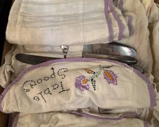 vintage flatware and embroidered storage bags